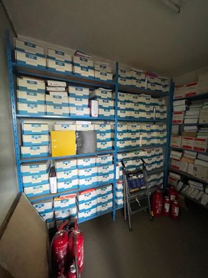 une pièce remplie d'une multitude de cartons empilés sur des étagères