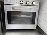 stainless steel counter top in a kitchen with a stove and refrigerator