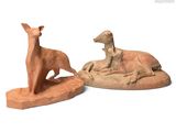 two figurines of a deer and a dog on a white background