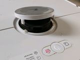 a close up of a washing machine with a button on it