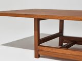 the table is made of solid wood and has a square top