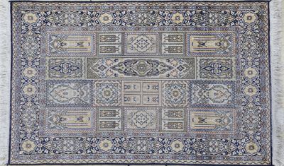 a blue and beige rug with a pattern on it