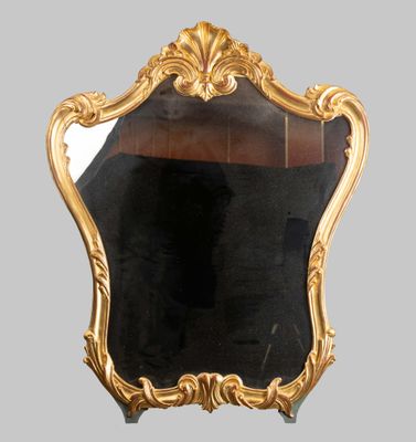 a mirror that has a gold frame on it