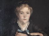 portrait of a young girl in a black dress with a blue bow tie