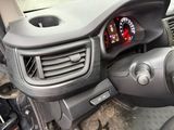 a car dashboard with a clock and a steering wheel