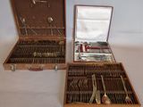 two wooden cases with silverware in them on a table