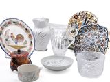 many different types of dishes and vases on the table