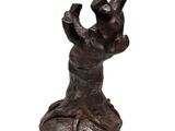 statue of a hand reaching out from a rock