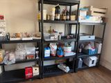 many shelves with various items on them in a room