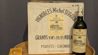 a bottle of wine sitting next to a box of cheese