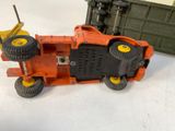 a toy tractor that is sitting next to a toy truck