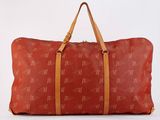 an image of a red duffel bag with a brown handle