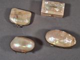 three pieces of mother of pearl and a box on a table