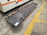 a machine that is sitting on the ground next to a bench