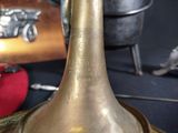 a brass bell sitting on top of a table