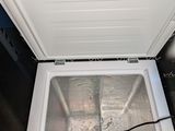 a white chest freezer that is open on the floor