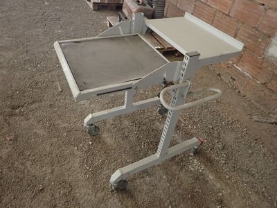 a small table with a tray on it in the dirt