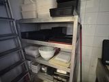 a kitchen with a lot of dishes on the shelves