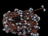 a close up of a string of pearls on a black background
