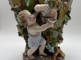 a figurine of a boy and a girl in a vase
