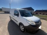a white van parked in a parking lot on a sunny day