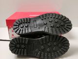 the sole of a pair of black shoes on top of a red box