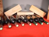 several bottles of wine are lined up on a red table