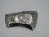 a metal object on a white surface with a white background