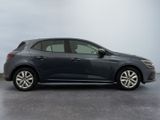 the grey car is parked on the concrete floor in the room