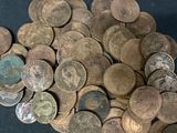 a pile of old coins sitting on a table