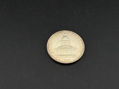 a coin with the capitol building in the background