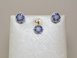 a close up of a pair of blue and white earrings