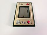 an old gameboy sitting on top of a white table