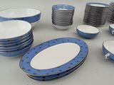 a lot of blue and white plates and bowls on the table