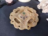 a small decorative object on a table next to other items