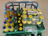 a cart full of bottles of soda and orange juice