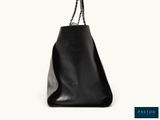 black leather tote bag with chain handles on a white background
