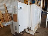 a white refrigerator that is sitting in a warehouse