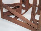 an old rusted metal rack with a clock on it