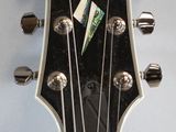 a close up of an electric guitar with a sticker on it