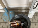 a black bucket with tools inside of it on the floor