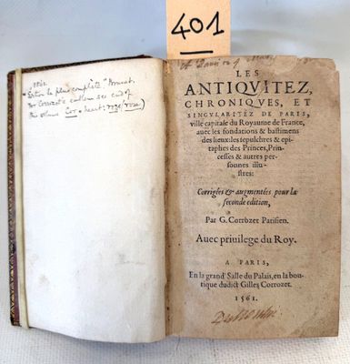 an old book with writing on it sitting on a table