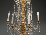 an antique brass chandelier with crystal drops and candles