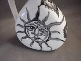 a white vase with a black and white design on it
