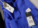 the label on a blue shirt is attached to a hanger