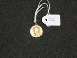 a gold medal with a white tag attached to it