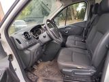 the interior of a car with the door open and the driver ' s seat down