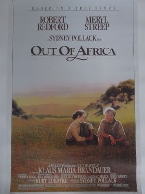 an image of a movie poster for out of africa with two men sitting in a field