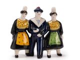 three figurines of people standing next to each other