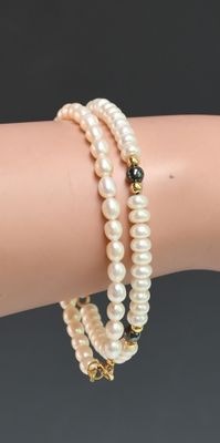 a close up of a person ' s arm with a bracelet on it